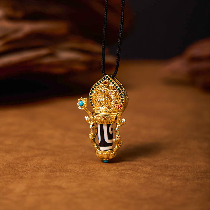 Tibetan Dzi Bead Manjusri Bodhisattva Necklace – necklace laid on brocade fabric, traditional Tibetan ceremonial context