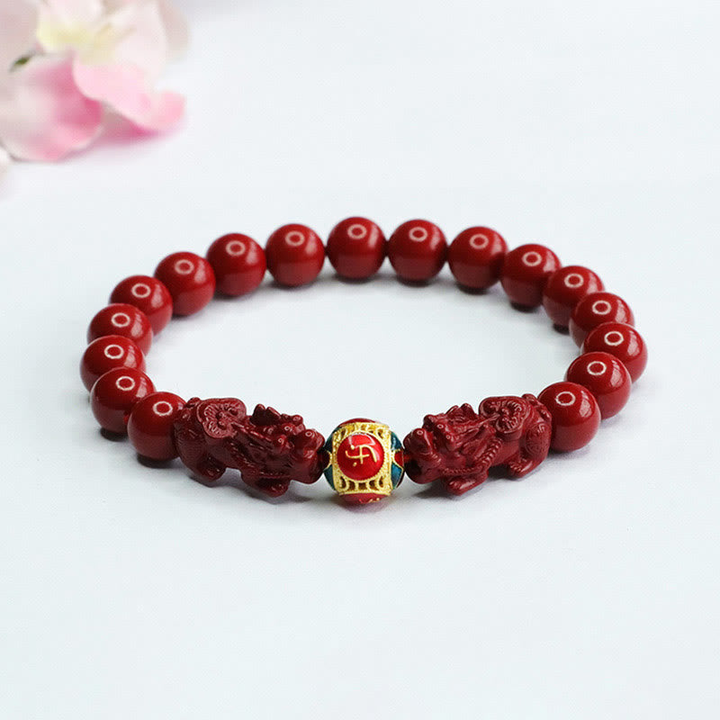 Cinnabar Double Pixiu Bracelet – red cinnabar beads with carved pixiu guardians and gold enamel fortune bead