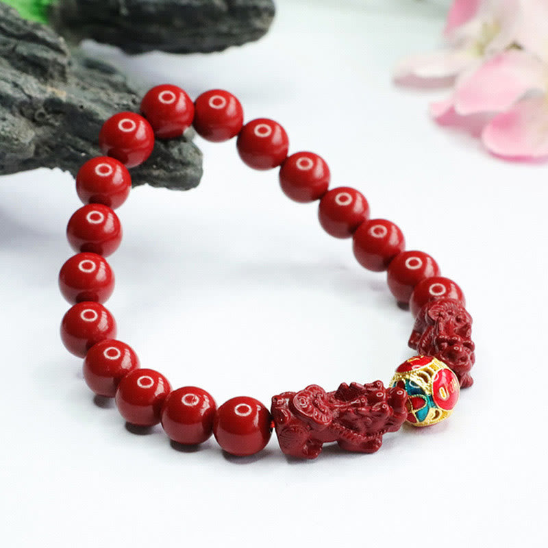 Cinnabar Double Pixiu Bracelet – pixiu facing outward with gold cloisonne center, rock and flower props