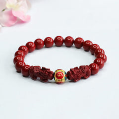 Cinnabar Double Pixiu Bracelet – red cinnabar beads with carved pixiu guardians and gold enamel fortune bead