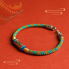 Colorful Six Words Silver Bracelet – Teal gold braid on red backdrop, ethnic