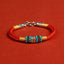 Om Mani Padme Hum Bracelet – Red cord flat lay with beads, woven