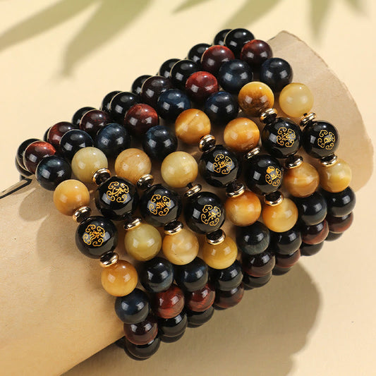 Black Onyx Tiger Eye Natal Buddha Bracelet - stacked on curved display, multi-color tiger eye