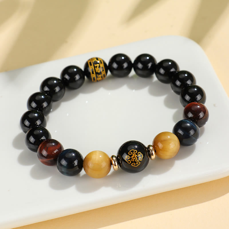 Black Onyx Tiger Eye Natal Buddha Bracelet - on ceramic dish, gold character focal bead