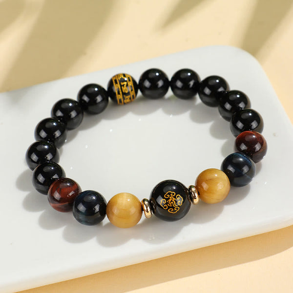 Black Onyx Tiger Eye Natal Buddha Bracelet - on ceramic dish, gold character focal bead