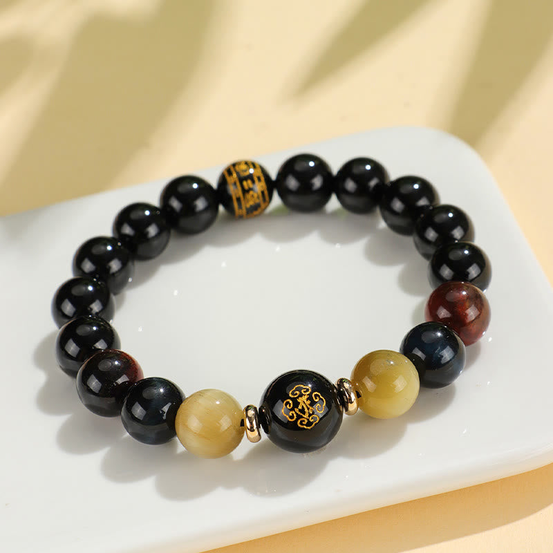 Black Onyx Tiger Eye Natal Buddha Bracelet - on ceramic dish, gold inscribed black beads