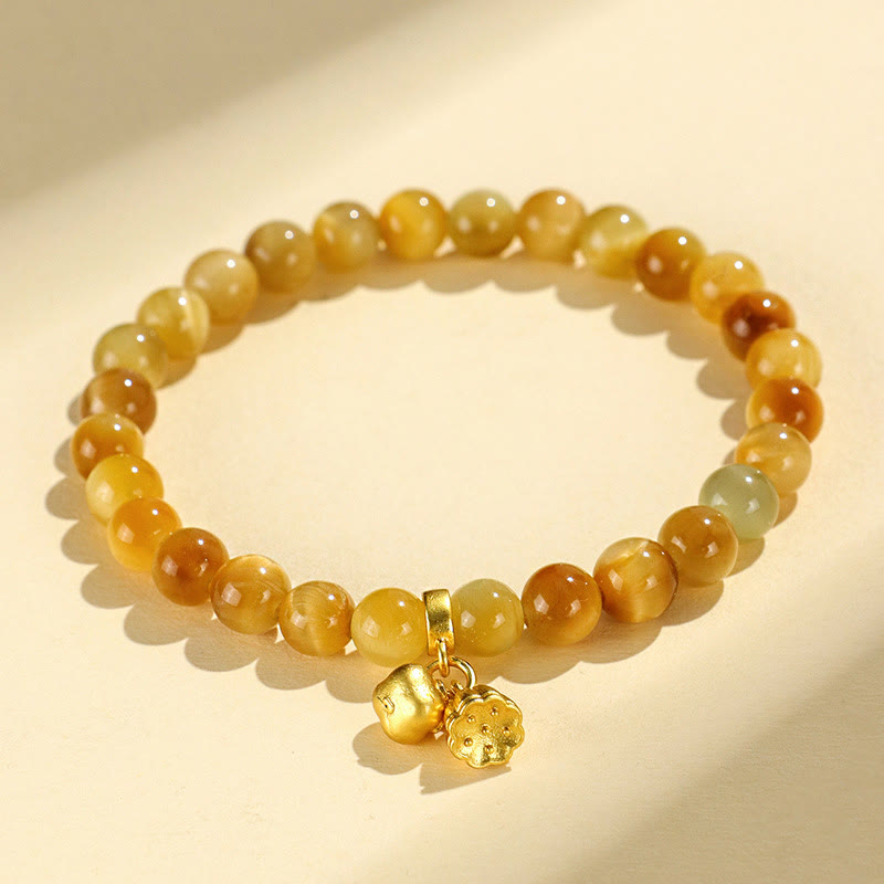 Tiger Eye Fu Bamboo Koi Lotus Bracelet – yellow jade beads with persimmon and flower gold charms on cream bg