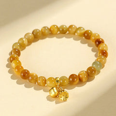 Tiger Eye Fu Bamboo Koi Lotus Bracelet – yellow jade beads with persimmon and flower gold charms on cream bg