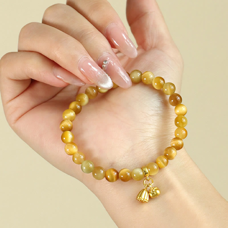 Tiger Eye Fu Bamboo Koi Lotus Bracelet – tiger eye beads with lotus pod charm on wrist, French manicure close-up