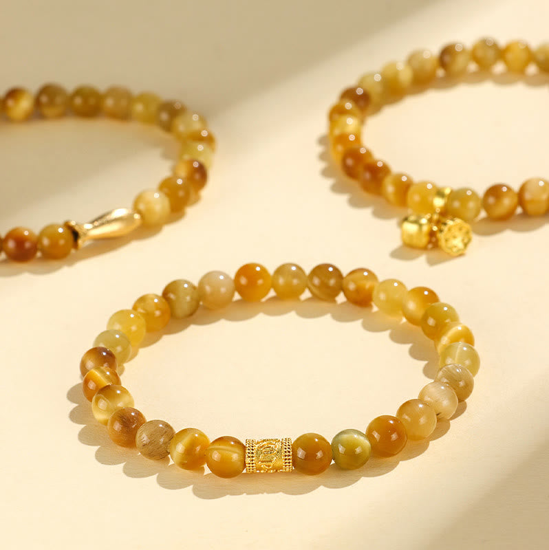 Tiger Eye Fu Bamboo Koi Lotus Bracelet – three tiger eye bracelets stacked on cream, gold charms, prosperity set