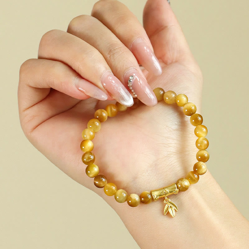 Tiger Eye Fu Bamboo Koi Lotus Bracelet – tiger eye beads with bamboo charm on wrist, close-up, prosperity jewelry
