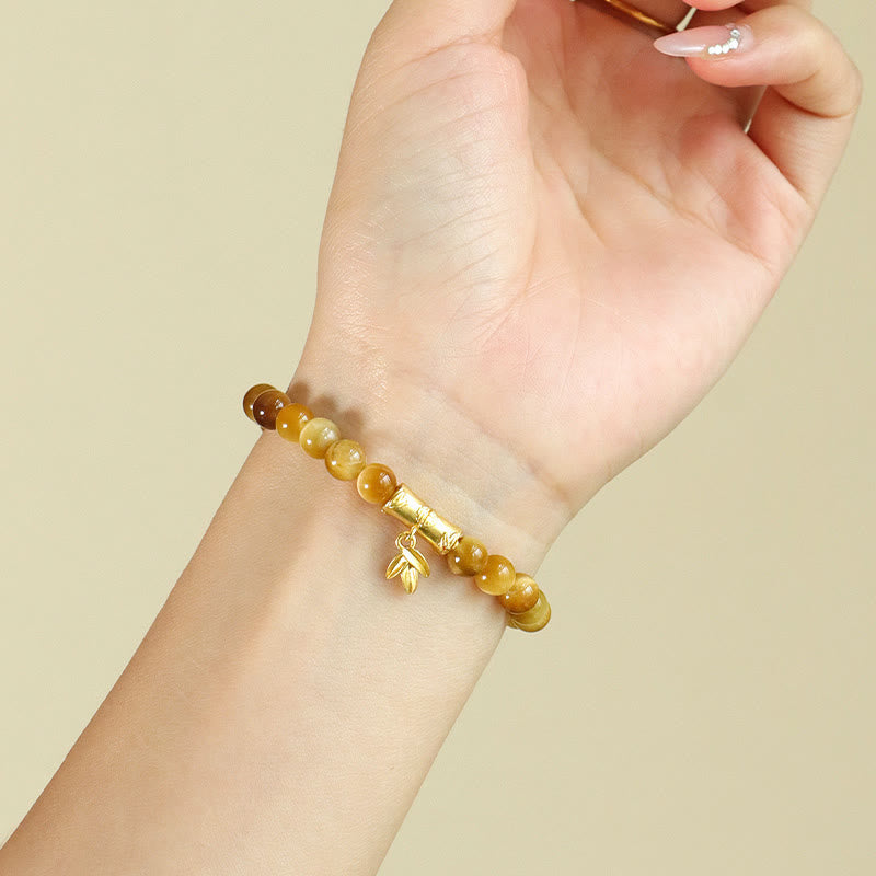 Tiger Eye Fu Bamboo Koi Lotus Bracelet – amber gradient beads with bamboo charm on wrist, three-quarter view
