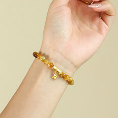Tiger Eye Fu Bamboo Koi Lotus Bracelet – amber gradient beads with bamboo charm on wrist, three-quarter view