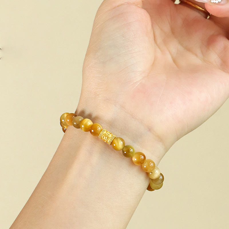 Tiger Eye Fu Bamboo Koi Lotus Bracelet – tiger eye beads with gold barrel charm on wrist, close-up, gemstone