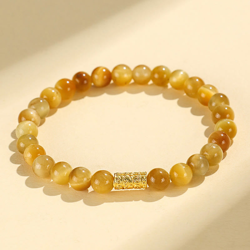 Tiger Eye Fu Bamboo Koi Lotus Bracelet – tiger eye beads with gold barrel charm on cream, flat lay, natural stone