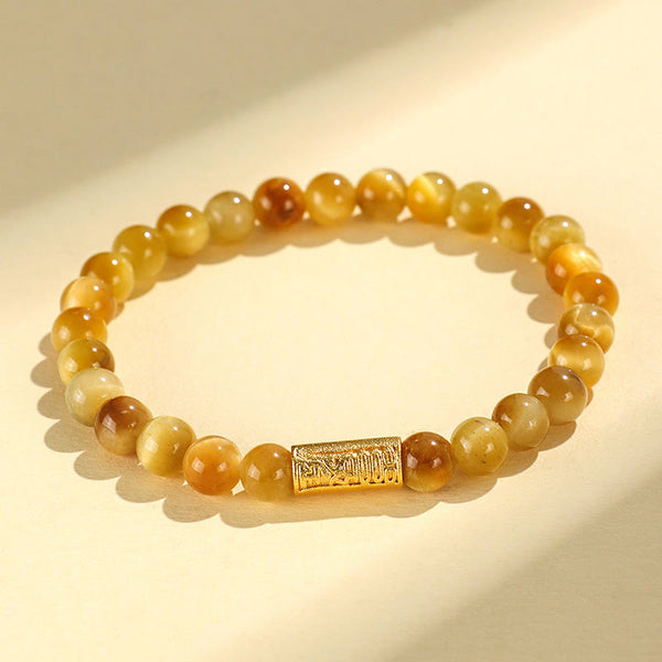 Tiger Eye Fu Bamboo Koi Lotus Bracelet – tiger eye beads with engraved gold barrel charm on cream, warm tones