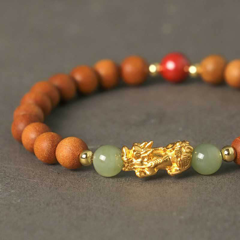 Multi-Wood PiXiu Bracelet – Close-up of gold PiXiu charm with green jade beads and light brown wood bracelet