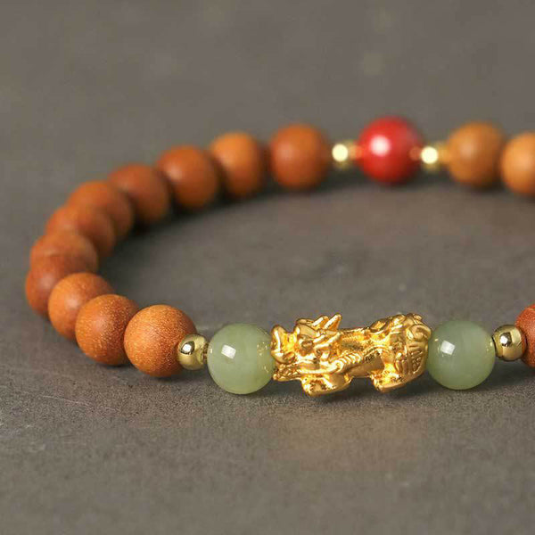 Multi-Wood PiXiu Bracelet – Close-up of gold PiXiu charm with green jade beads and light brown wood bracelet