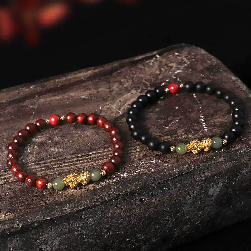 Multi-Wood PiXiu Bracelet – Red sandalwood and black ebony bracelets paired on dark volcanic rock