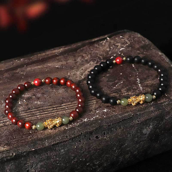 Multi-Wood PiXiu Bracelet – Red sandalwood and black ebony bracelets paired on dark volcanic rock