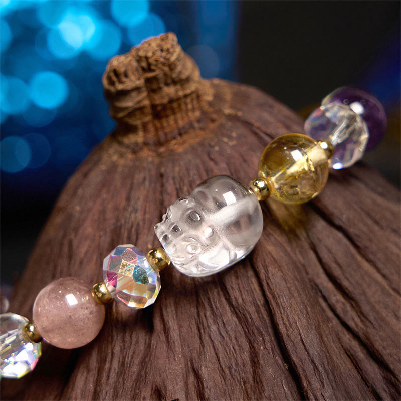 PiXiu White Crystal Bracelet – Macro of clear crystal PiXiu on dark wood with blue bokeh, feng shui