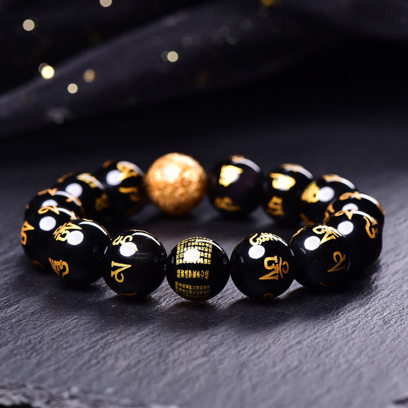 Rainbow Obsidian Mantra Bracelet - Close-up of gold mantra text on obsidian beads, spiritual jewelry