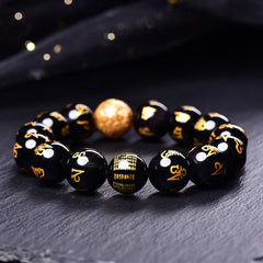 Rainbow Obsidian Mantra Bracelet - Close-up of gold mantra text on obsidian beads, spiritual jewelry