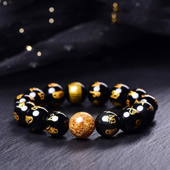 Rainbow Obsidian Mantra Bracelet - Gold-inscribed black beads with golden accent on dark stone, mantra bracelet