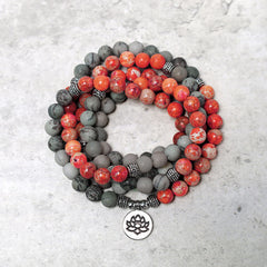108 Mala Beads Sea Sediment Jasper Lotus Bracelet – Coiled red gray bead wraps on stone surface with lotus pendant, jasper