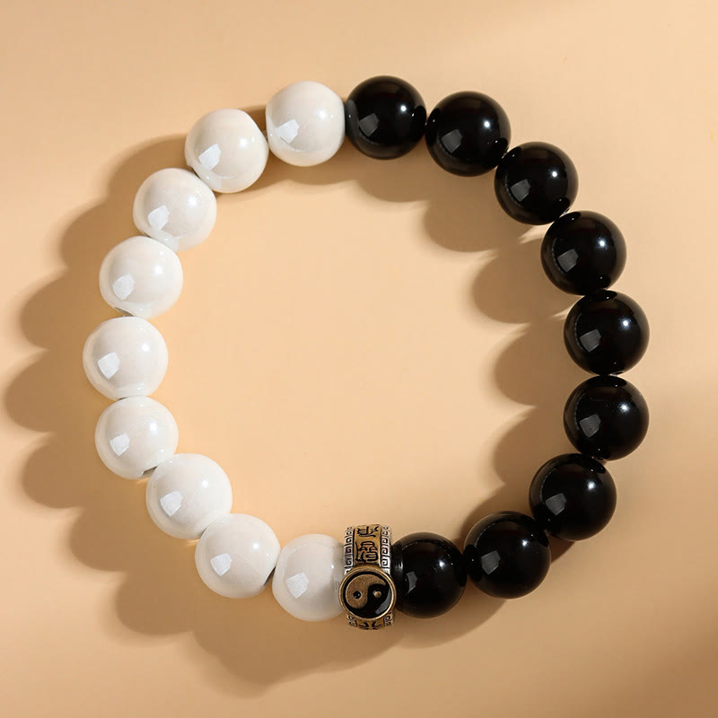Black Obsidian White Porcelain Yin Yang Bracelet - Flat-lay yin-yang beaded bracelet with metal center charm, dual stone bracelet