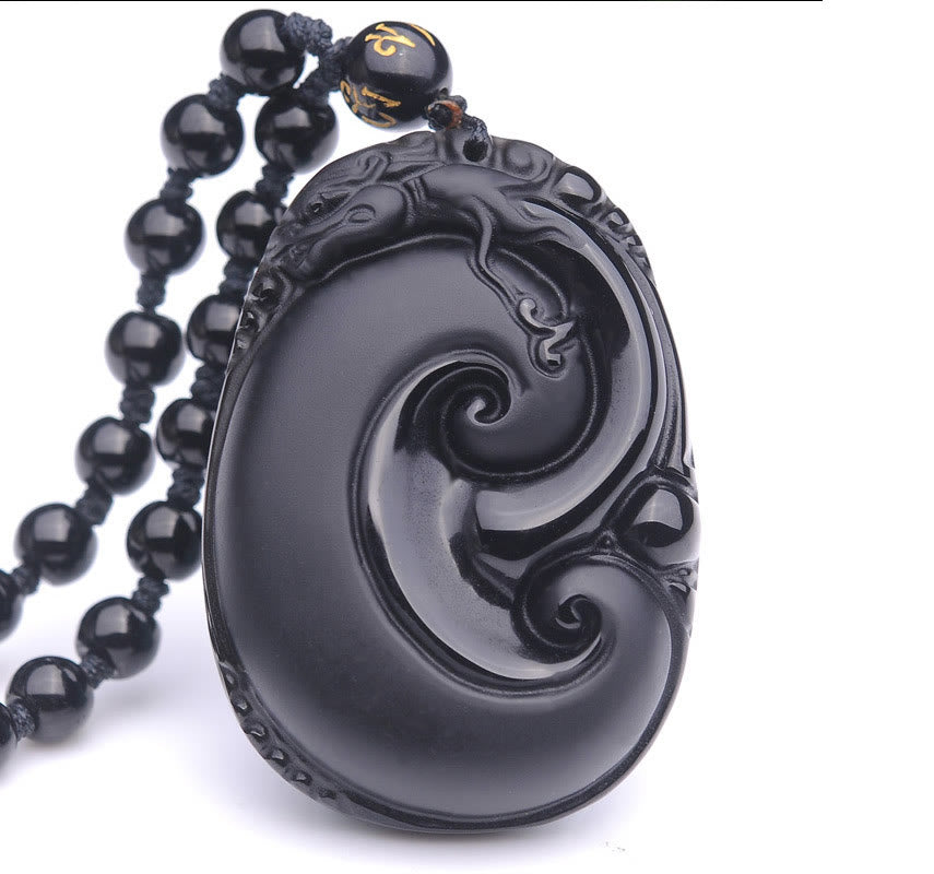 Black Obsidian PiXiu Pendant – Oval obsidian swirl pendant isolated on white with beads