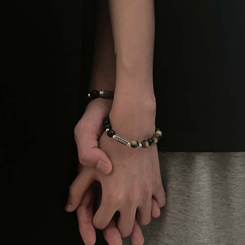 Black Obsidian Tiger Eye Bracelet – Wrist shot showing natural stone beads with silver mantra bar, mens healing bracelet
