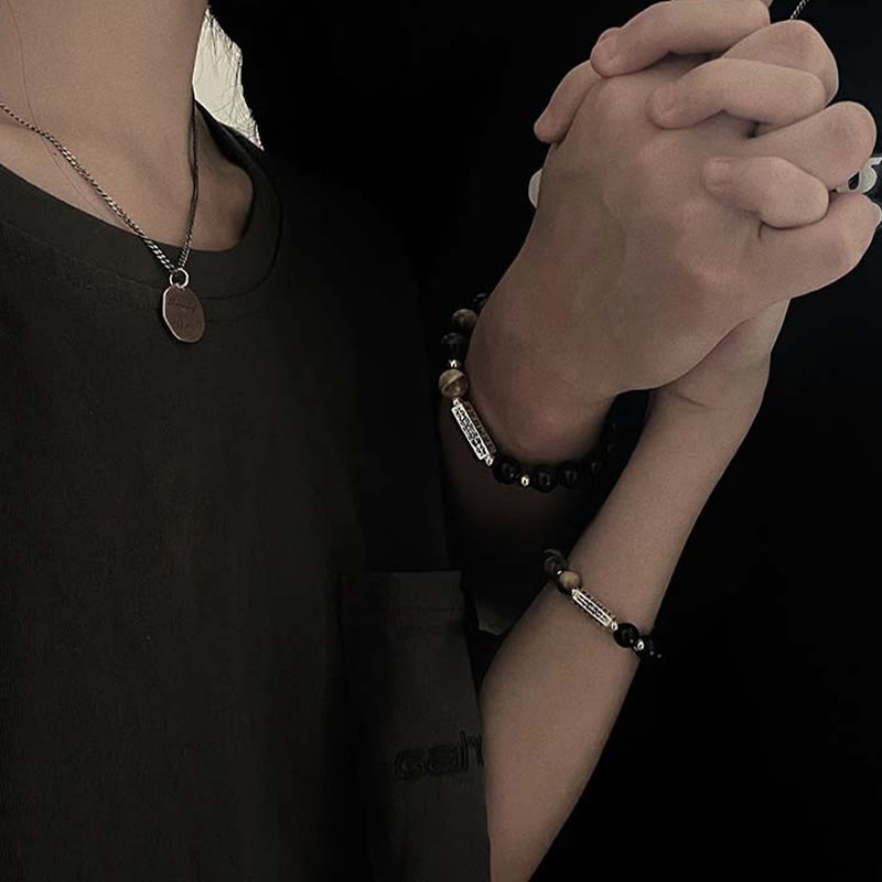 Black Obsidian Tiger Eye Bracelet – Matched couple bracelets on clasped hands, obsidian tiger eye jewelry