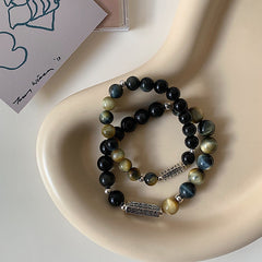 Black Obsidian Tiger Eye Bracelet – Pair on cream ceramic dish with chatoyant stone beads, mens beaded bracelet