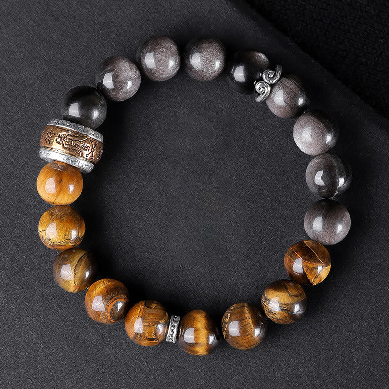 Om Mani Padme Hum Bracelet – Flat lay on dark fabric showing three stone types and carved metal