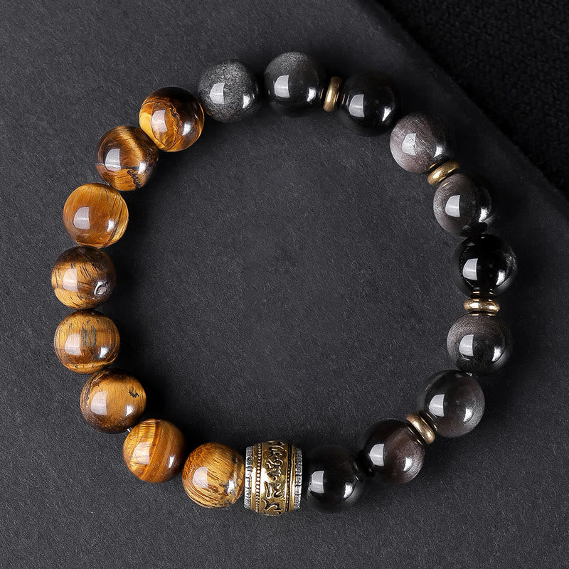 Om Mani Padme Hum Bracelet – Top-down showing tiger eye and obsidian split, ornate center bead