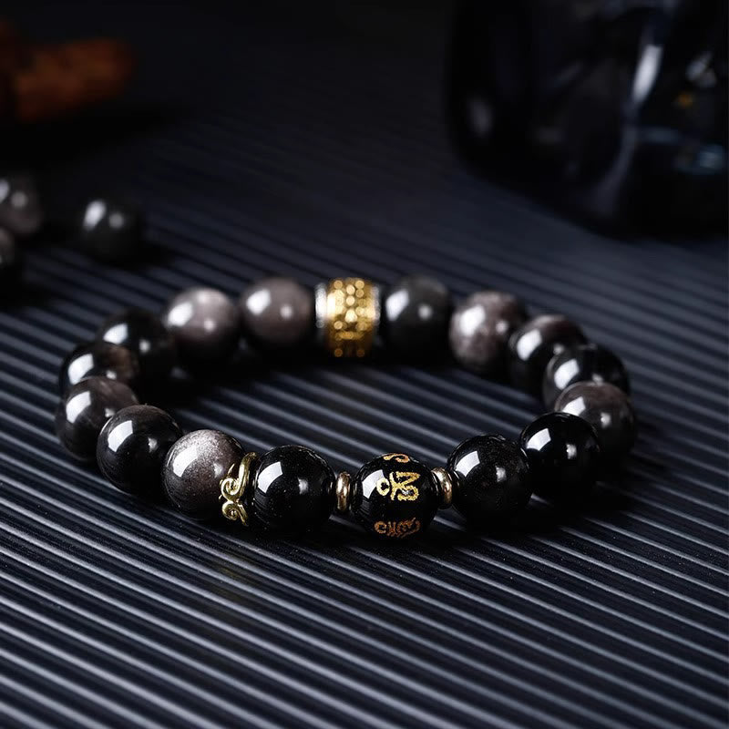 Om Mani Padme Hum Bracelet – Low angle on ribbed surface, gold Om mantra on black bead