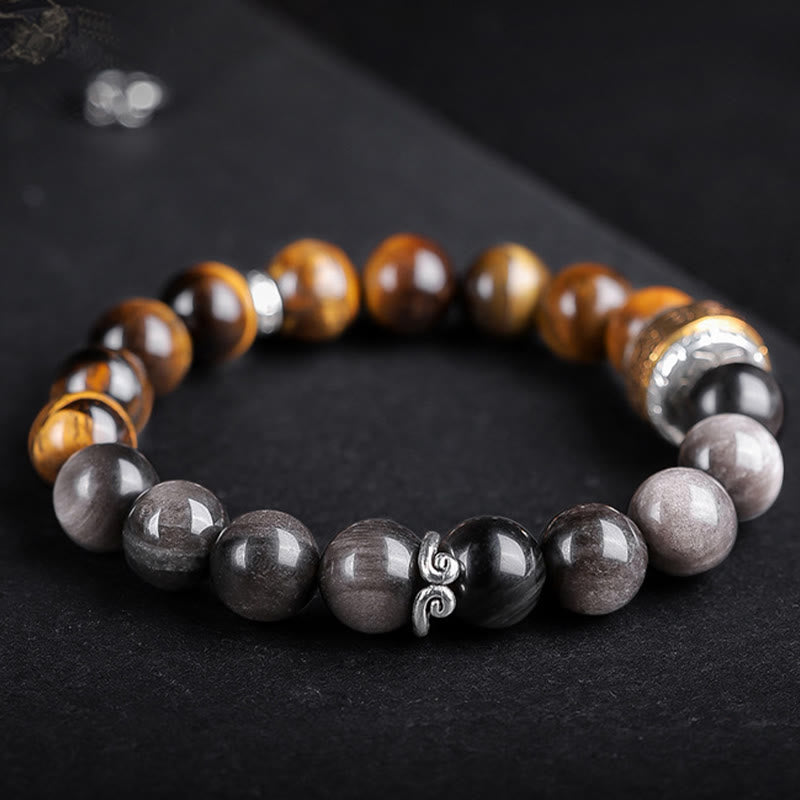 Om Mani Padme Hum Bracelet – Angled view on matte black, tiger eye and silver obsidian beads