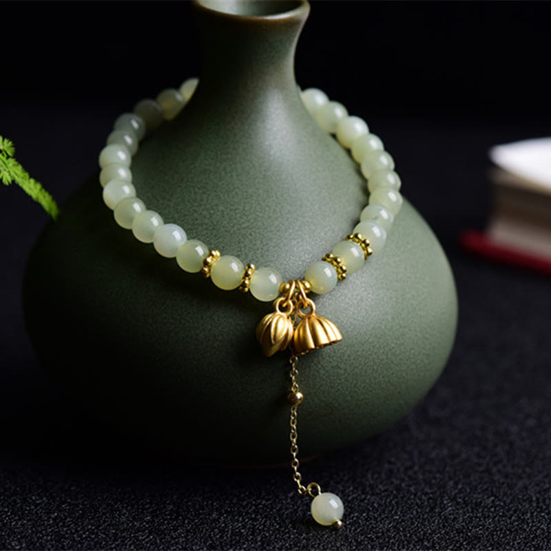 Natural Hetian Jade Lotus Bracelet - jade beads draped on celadon vase with lotus pods, abundant