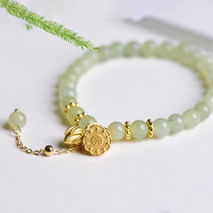 Hetian Jade Lotus Luck Bracelet - pale jade beads with gold lotus flower charm, balanced