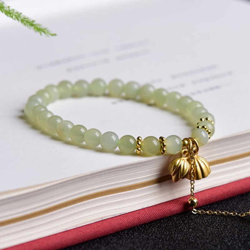 Natural Hetian Jade Lotus Bracelet - lotus pod charm detail on open book, flourishing