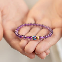 Natural Amethyst Lotus Spiritual Awareness Bracelet - purple amethyst held gently in cupped hands, healing