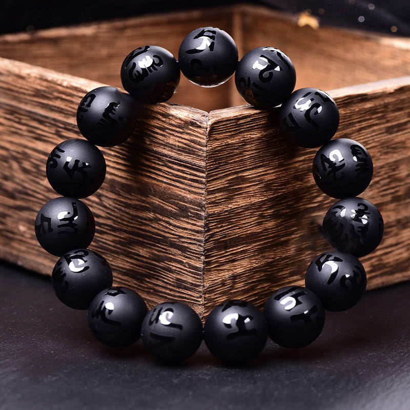Black Onyx Mantra Bracelet – Beaded bracelet with engraved silver-toned mantra on rustic wood, protection jewelry