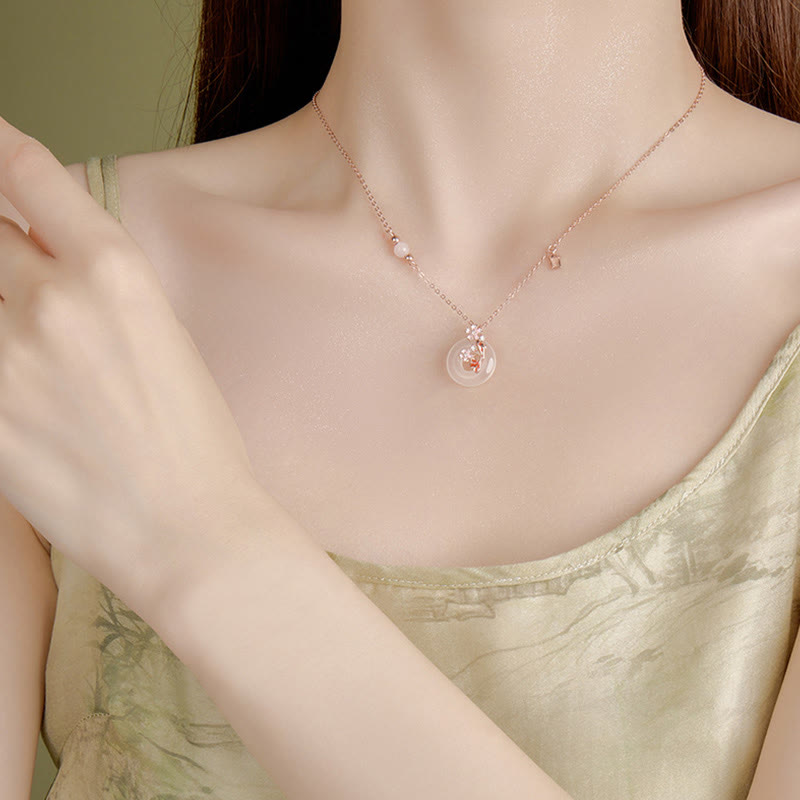 Chalcedony Koi Fish Peace Buckle Necklace – worn on decolletage, circular floral jade pendant, pale green camisole
