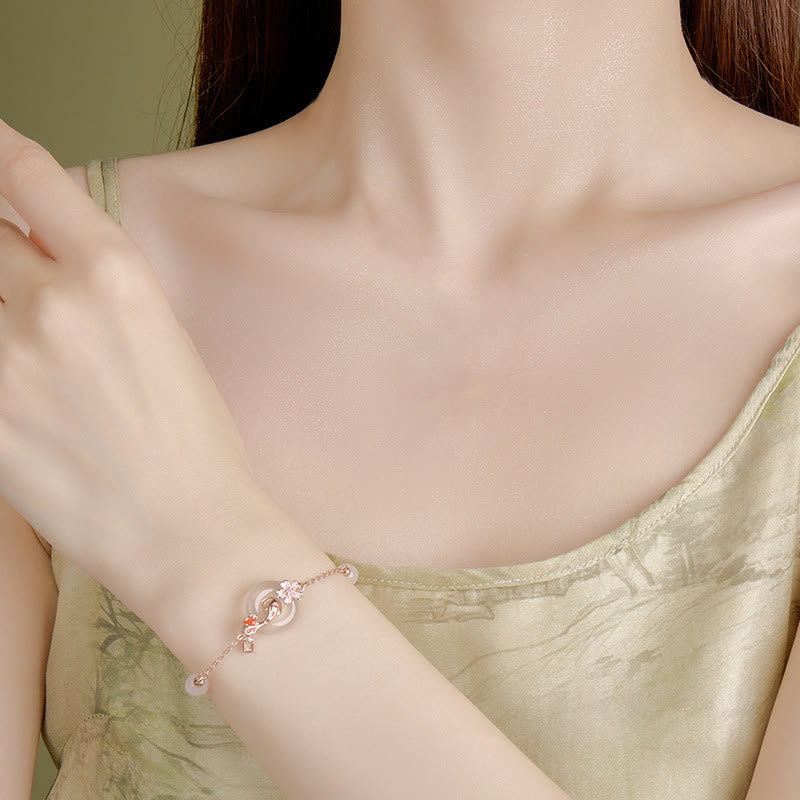 Chalcedony Koi Fish Peace Buckle Bracelet – wrist close-up, double-ring jade centerpiece, sage green camisole, olive wall