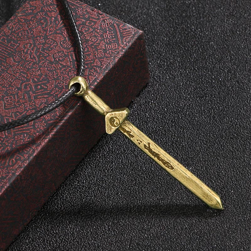 Vintage Yin Yang Copper Sword Necklace - antique copper sword pendant with yin-yang on crossguard, hanging from black cord... Hauptbild