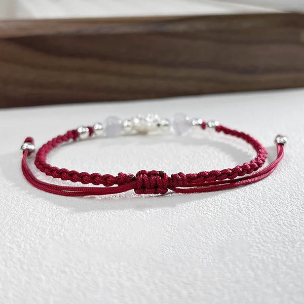Sterling Silver Lotus Cat's Eye String Bracelet - double-strand burgundy cord with white beads, refined