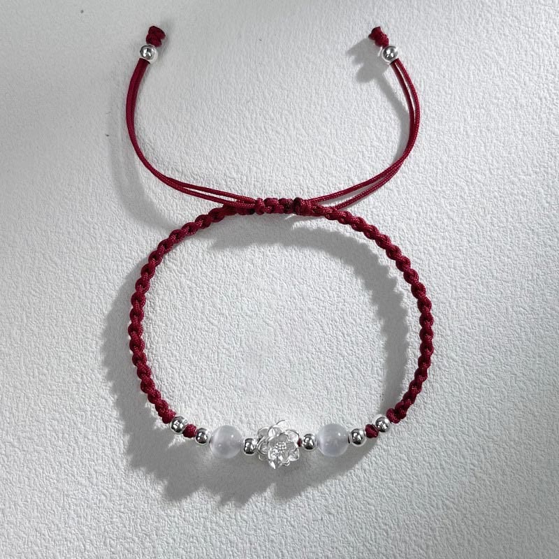 Sterling Silver Lotus Cat's Eye String Bracelet - burgundy cord on textured white, spiritual calm