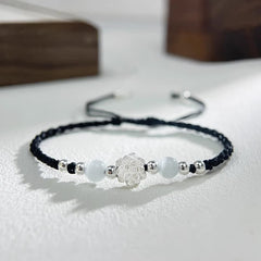 Sterling Silver Lotus Cat's Eye String Bracelet - black cord with silver lotus and white cat's eye beads, clarity