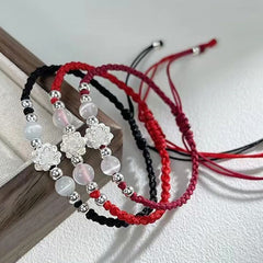 Sterling Silver Lotus Cat's Eye String Bracelet - three cord color variants on dark wood prop, elegant